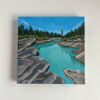 Square acrylic painting of Rocky Mountains and blue water with reflections
