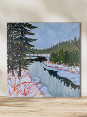 winter scene of snowy trees reflected in frozen water