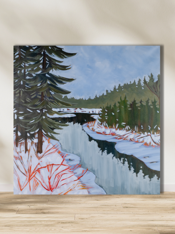 winter scene of snowy trees reflected in frozen water